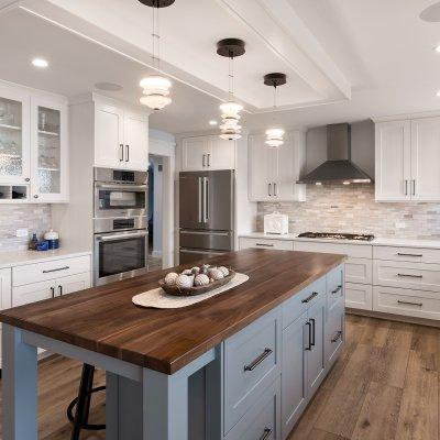 kitchen with white cabinets and large blue island